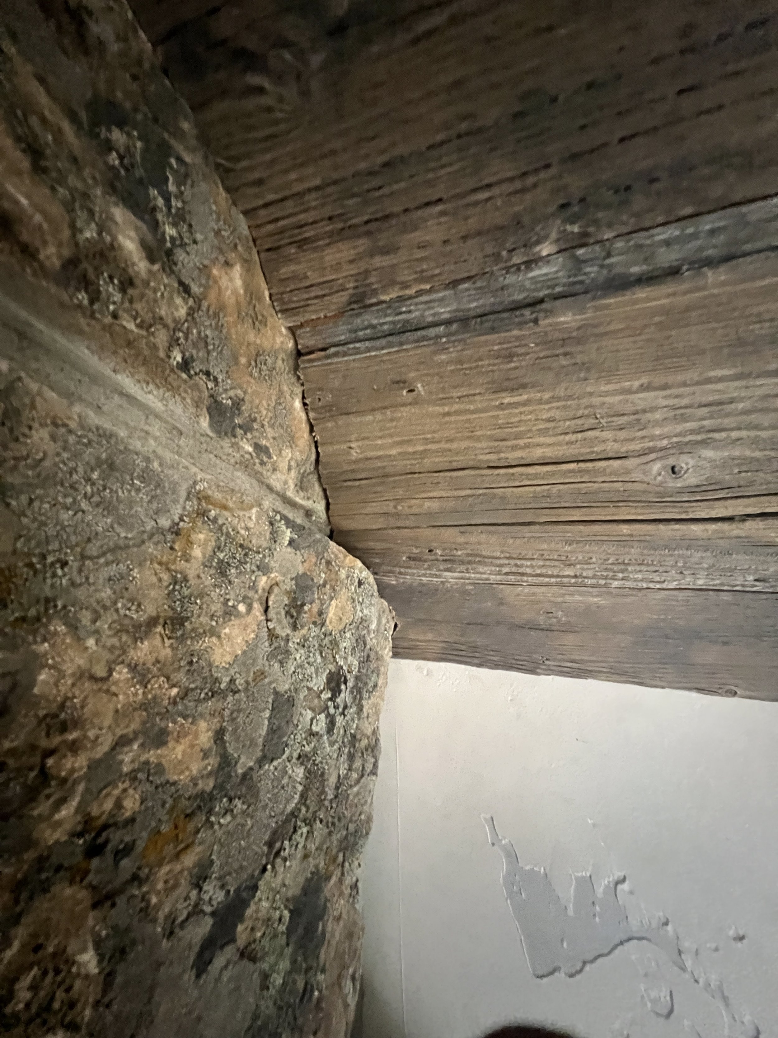 Close-up of rustic wood and stone detail during interior finish work.